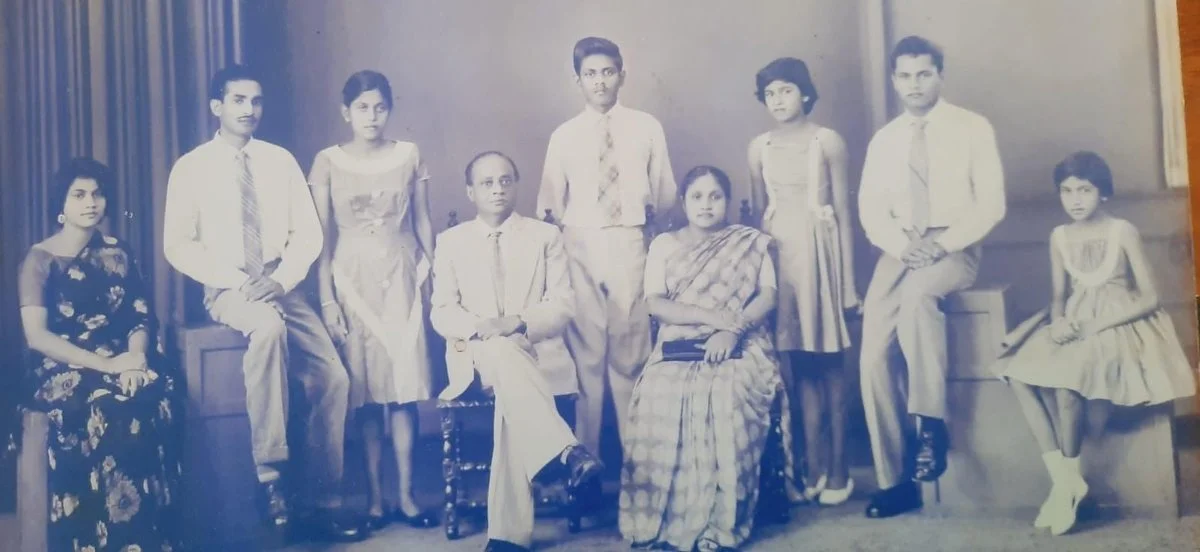 Black-and-white family portrait of a young Quintus Andradi with his parents and six siblings.
