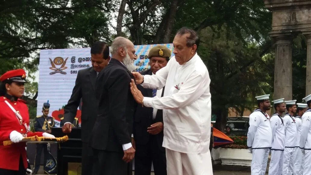 Quintus Andradi receiving a medal from the Speaker of the House, Hon. Karu Jayasuriya, in a Navy honour ceremony.